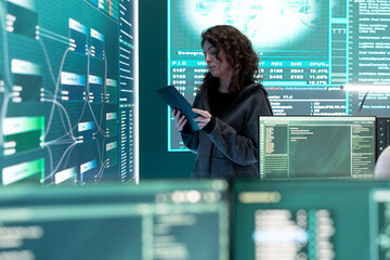 Cyber security expert investigates governmental hacking malware attack on big screen, high tech center. Cybercriminal woman hacks computer systems, threatening database protection.