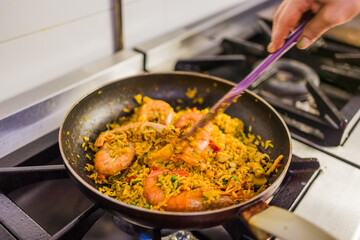 Chef preparing traditional ecuadorian dish with rice and shrimp in ecuador restaurant