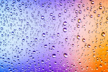 Colorful water droplets on glass background. (1)