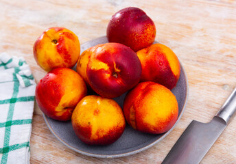 Fresh organic nectarine on wooden background, fruit vegan food