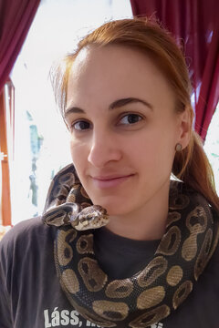 Young woman with a giant snake