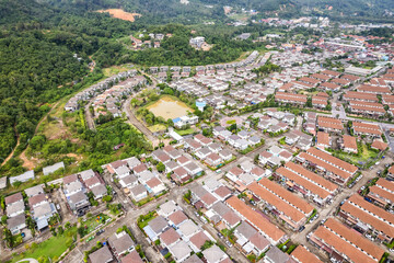 Obraz premium New development real estate. Aerial view of residential houses and driveways neighborhood during a fall sunset or sunrise time. Tightly packed homes. Top view over private houses in phuket thailand