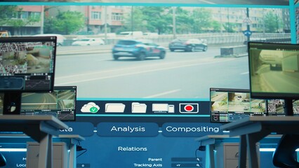 Government agency employing CCTV system in empty monitoring room with traffic surveillance video...