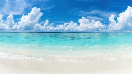Fototapeta premium Enjoy the serene beauty of a sandy beach with calm turquoise waves and white clouds on a sunny day in paradise.