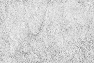Soft shaggy white carpet texture. Fluffy synthetic textile fur, plush textile, blanket cloth background. Wallpaper, backdrop, solid color