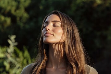 Naklejka premium A woman with long brown hair is sitting in the sun