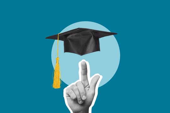 Graduation ceremony hat and student hand