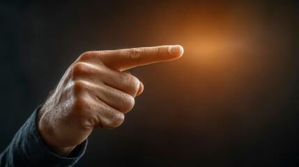 Businessman pointing his finger at a dark background, with a blank area for text, representing focus, clarity, and the power of non-verbal communication in business.