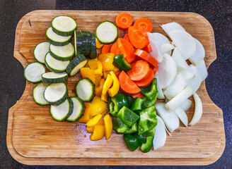 Chopped raw vegetables on a wooden chopping board.