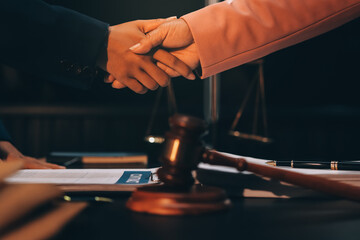 Judge gavel with Justice lawyers having team meeting at law firm background. Concepts of Law and Legal services.