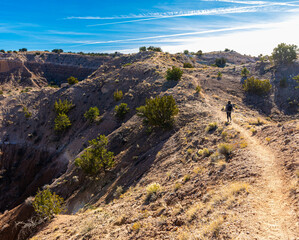 Female Hiker on Ridge in Desert Landscape, Nambe Badlands, Nambe, New Mexico, USA
