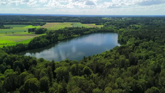 Steinsee bei Munchen Luftaufnahme. Steinsee, See in Bayern Luftbildansicht. Lake Stein aerial view near Munich, Bavaria, Germany. One of warmest lakes in Germany. Steinsee is located in forest area. 