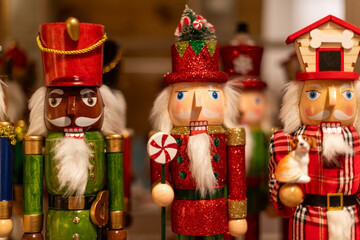 Multiple wooden painted traditional toy soldier or Christmas nutcracker figurines. The drummers are...