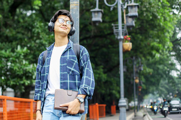Asian Student Man Walking in Urban Park