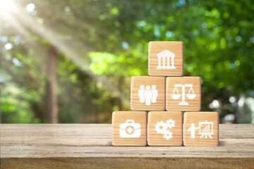 Social policy.  Wooden cubes on desk with icon