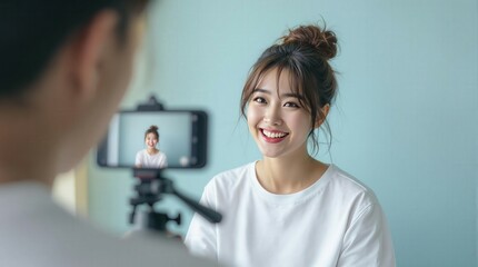 Fototapeta premium A close-up of a young woman streaming, showcasing her enthusiasm and connection with her audience, ideal for content creation and social media themes.