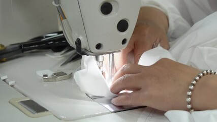 Skilled workers mending garments in live demonstration from a sewing workshop