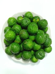 Fresh, vibrant green Kaffir Lime Fruits in a Dish