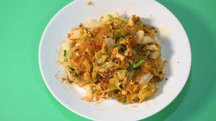 stir fried sukiyaki with egg and pork on white plate