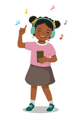 Cute little African boy listen to music with headphone 