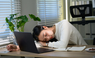 Young asian woman, tired freelancer or office worker sleeping on laptop keyboard after long working day at home office, burnout, stress, exhaustion and overworking concept
