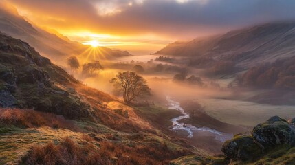 Naklejka premium Majestic sunrise over misty valley, illuminating hills, trees, and river.