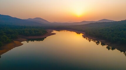 Obraz premium Serene Sunset Over Tranquil River Reflecting Mountains and Lush Greenery in a Peaceful Landscape of Nature's Beauty and Harmony