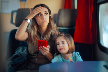 Mom Checking Phone Worried about Train Travelling. Mother feeling confused and concerned if she...