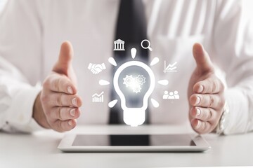 Business solution concept. Businessman hold light bulbs