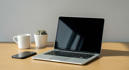 Minimalist Workspace with Laptop, Smartphone, and Cactus