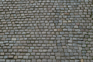 Background of cobblestone. Architecture background with stone cladding road. Concrete tiles...