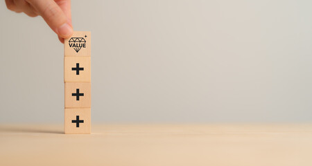 Value added concept. Way to adding value to product and service. Wooden blocks with value added...