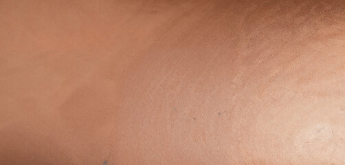 Fototapeta premium A close-up of luxurious satin fabric in a bronze shade, showcasing smooth folds, soft texture, and elegant shimmer, perfect for adding a touch of sophistication and glamour to any design.