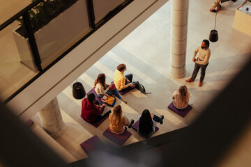 Professor giving lesson to university students in modern building