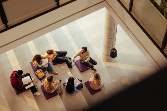 University students studying and learning together in modern building