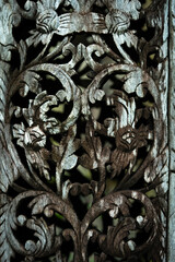 A plank of old carved wood.Pattern of flower carved on wood background.