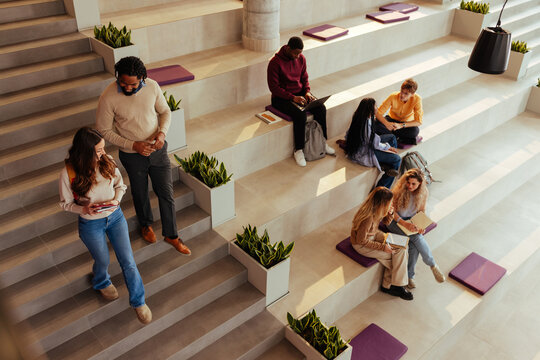 University students walking and studying in modern bleachers