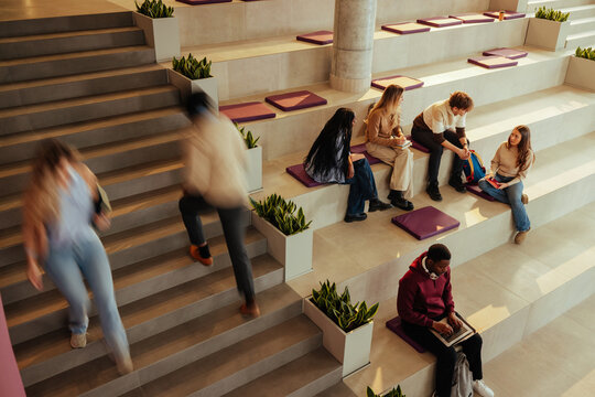 Students walking and studying in modern university building