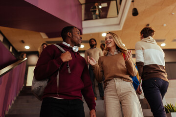 University students walking and talking on stairs