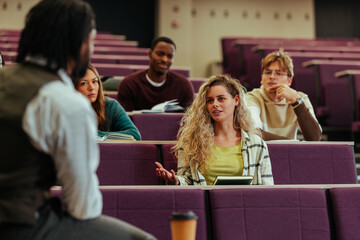 University student asking question during lecture in a classroom