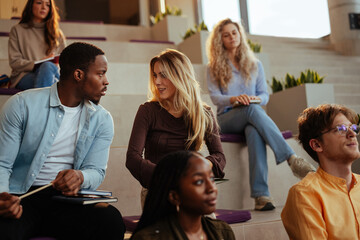 University students talking and learning in modern auditorium