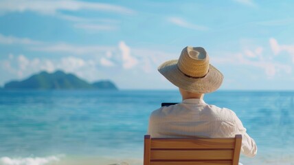 A serene beach scene featuring a person in a straw hat relaxing in a chair, gazing at the ocean and distant islands under a clear blue sky.