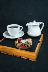 cup of tea and teapot on wooden table flower