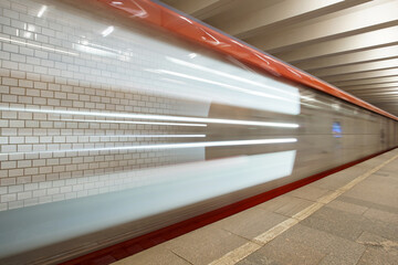 Blurred fast moving subway train. Fast moving passenger train arriving at the station.