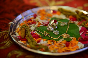 Mangalsutra Indian Neckless Jewelry on leaf and red powder. Indian Wedding Rituals		