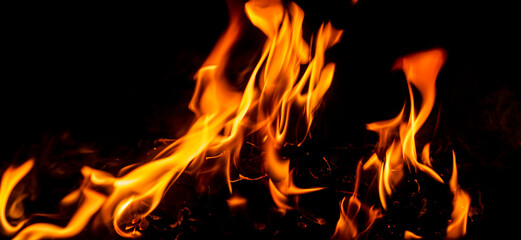 Fire flame background. Hell bonfire. Texture of fire on a black background. Blaze flames background for banner. Burning flames. Fire texture.