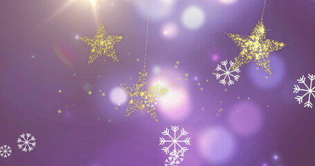 Fototapeta premium Image of falling white snowflakes and gold christmas stars swinging over defocussed lights