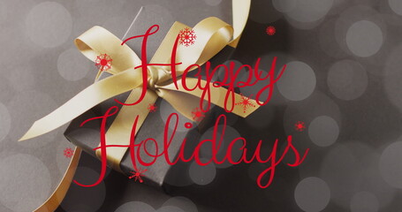 Image of christmas greetings text over christmas present © vectorfusionart