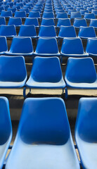 Closeup of blue seats in a stadium bottom to top view