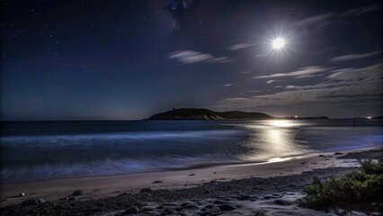 Fototapeta premium Moonlit Beach with Silky Waves and a Distant Island